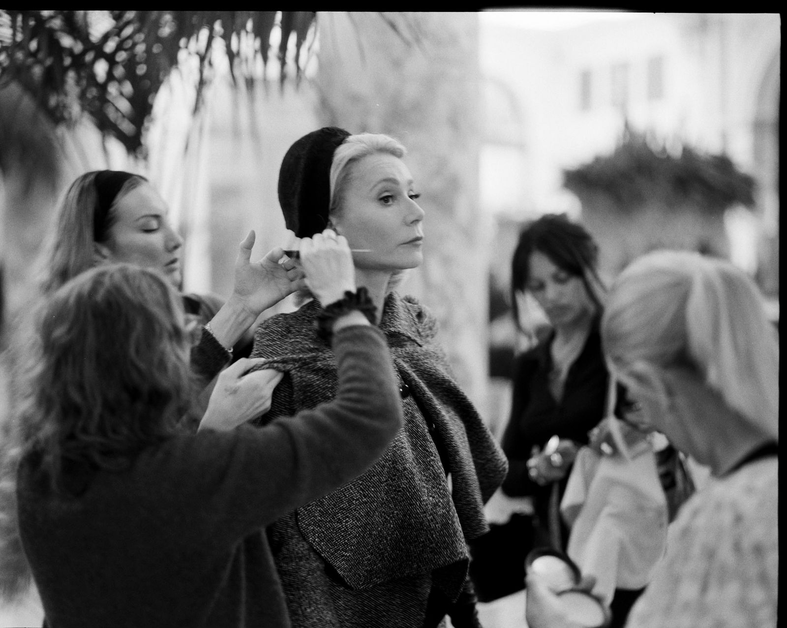 Image may contain Gwyneth Paltrow Body Part Finger Hand Person Cap Clothing Hat Adult Coat Face and Head